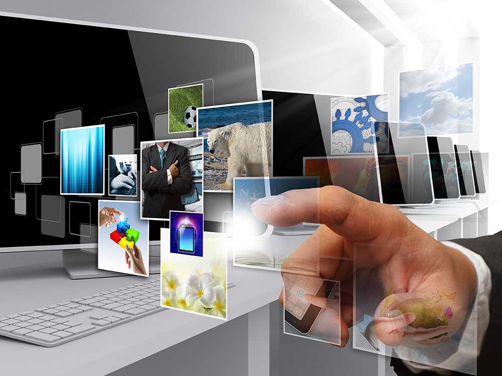 A conceptual illustration of a hand swiping photos streaming out of a computer.