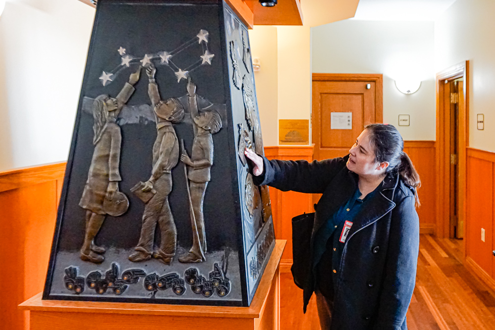 Woman touches tactile sculpture